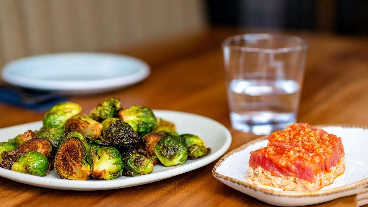 Close-up of healthy Yard House happy hour choices like Brussels sprouts and tuna stack.